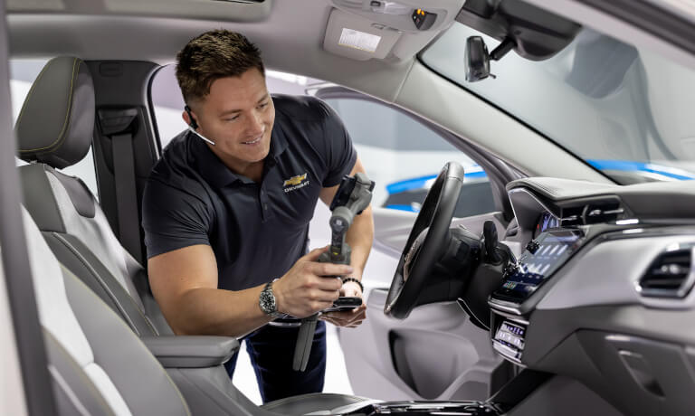 Product specialist checking a vehicle over with an instrument