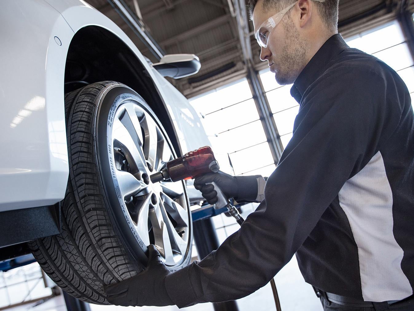 A Chevrolet certified service technician performing routine maintenance on a vehicle
