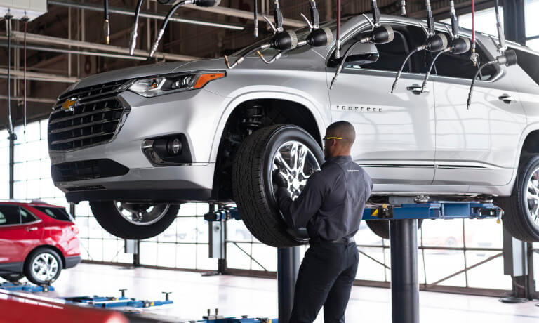 Technician replacing a tire on a Chevy
